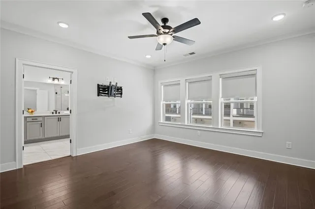 an empty room with a window and a ceiling fan