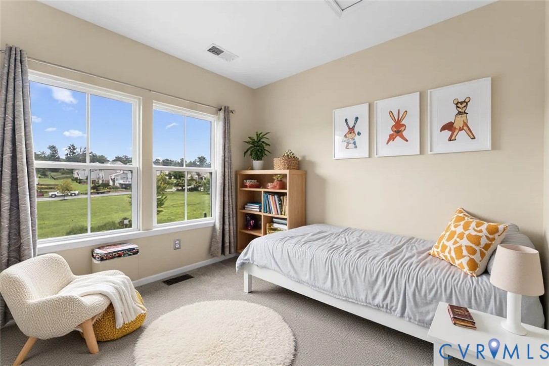 7809 Chasing Lane Richmond, VA 23237 - Photo 14 of 23 a bedroom with a bed and glass window