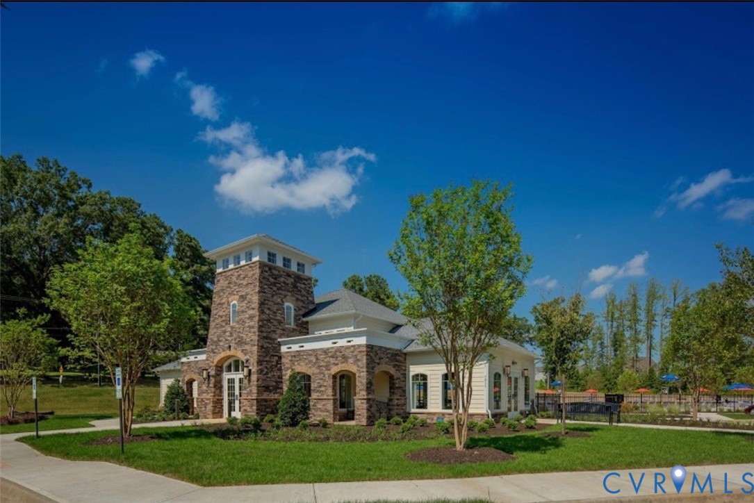 7809 Chasing Lane Richmond, VA 23237 - Photo 21 of 23 a view of a white house next to a yard with big trees