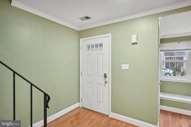 a view of an entryway with wooden floor