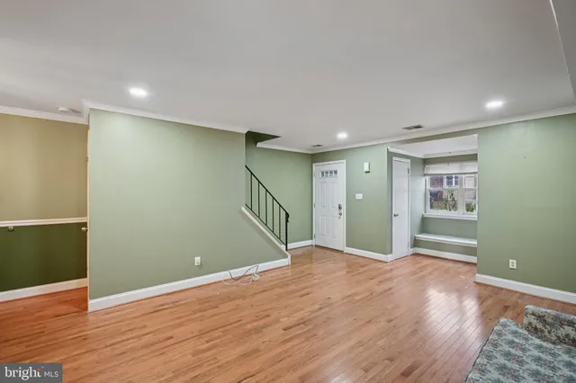 a view of an empty room with wooden floor