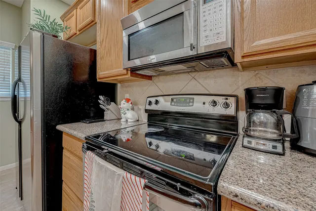 a stove top oven sitting inside of a kitchen