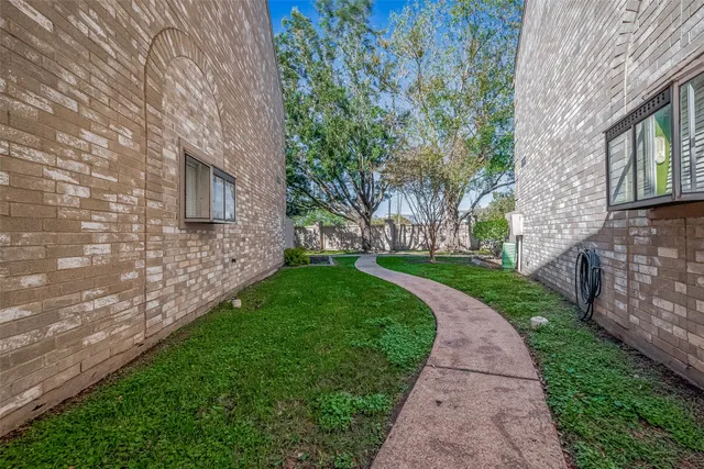 a view of a brick house with a yard