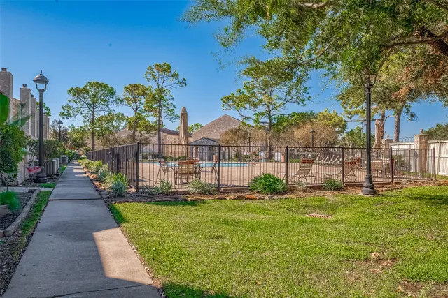 a view of a garden with a building in the background