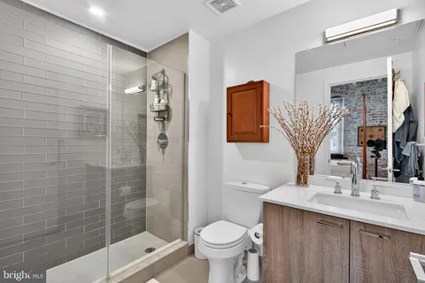 a bathroom with a sink toilet and shower