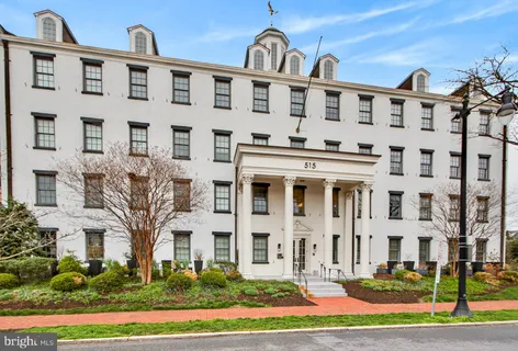 a front view of a building with a yard