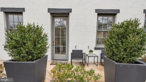 a house with potted plants in front of it