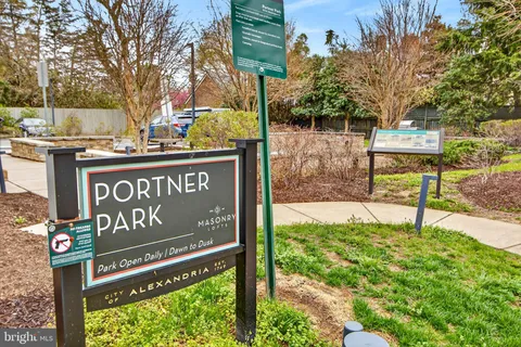 a view of a street sign under a large tree