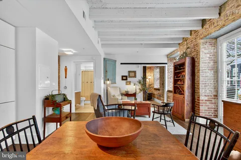 a living room with furniture a table and chairs