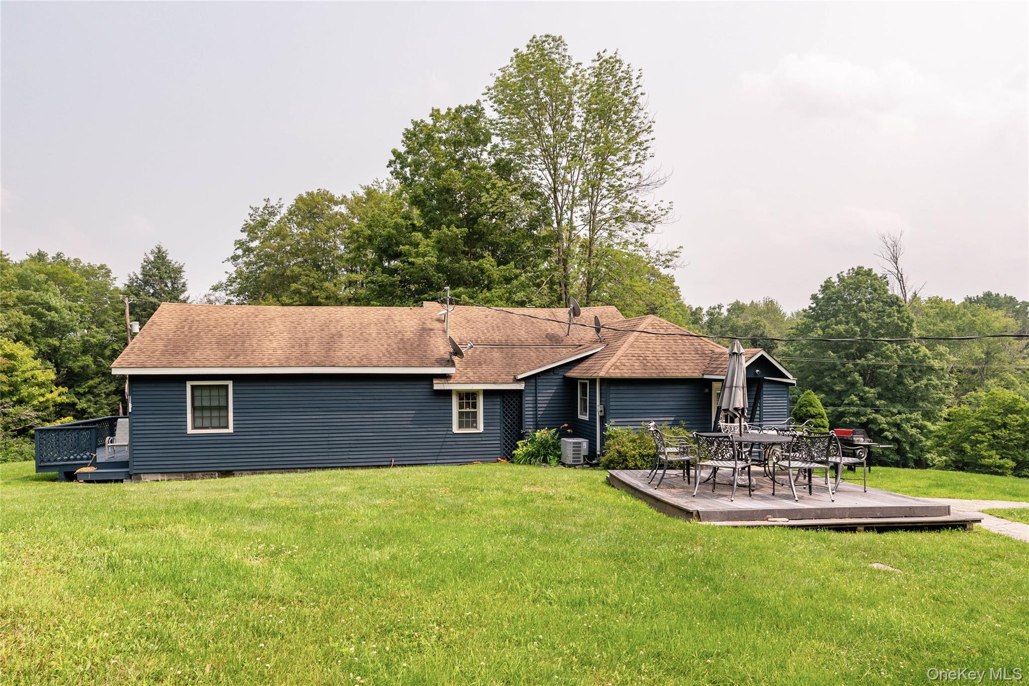 a front view of a house with a yard table and chairs