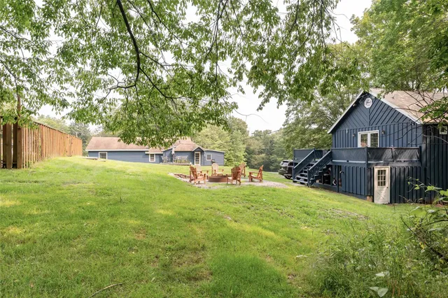 a view of a house with a yard and sitting area