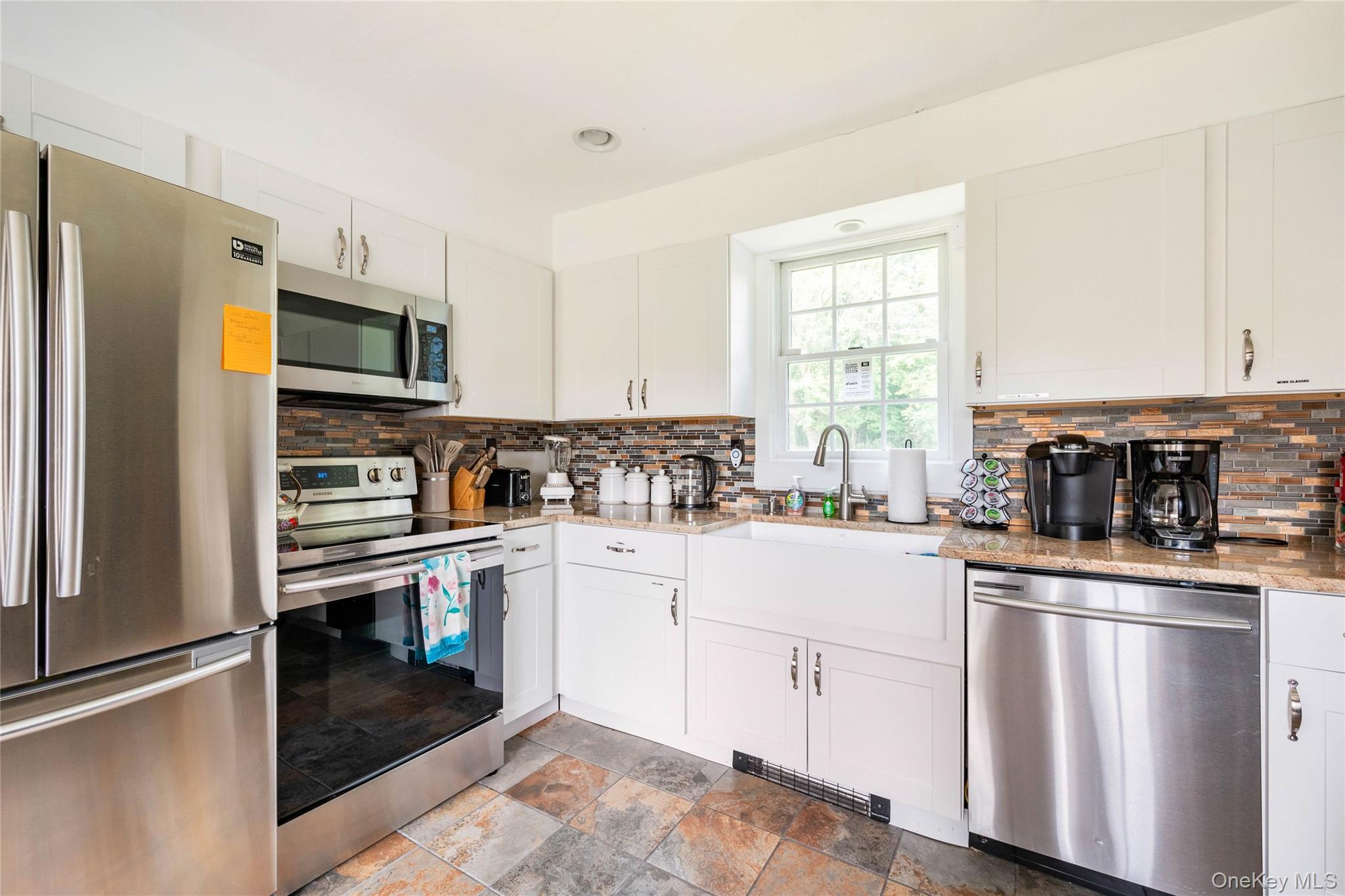 670 Creamery Road Mongaup Valley, NY 12762 - Photo 27 of 47 a kitchen with white cabinets and appliances