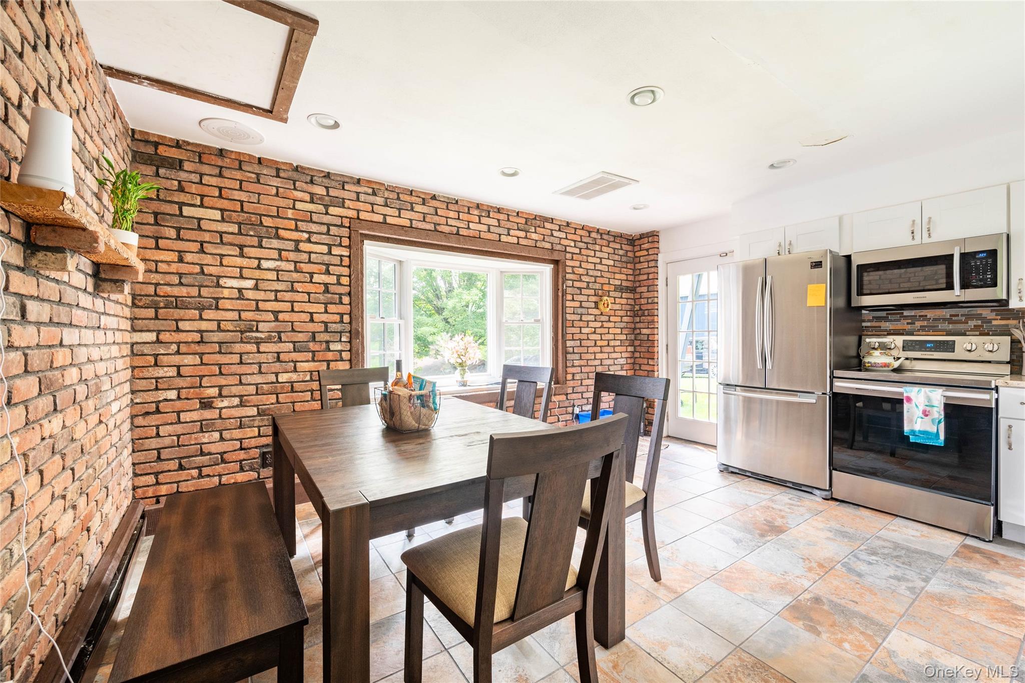 670 Creamery Road Mongaup Valley, NY 12762 - Photo 30 of 47 a kitchen with a table chairs and microwave
