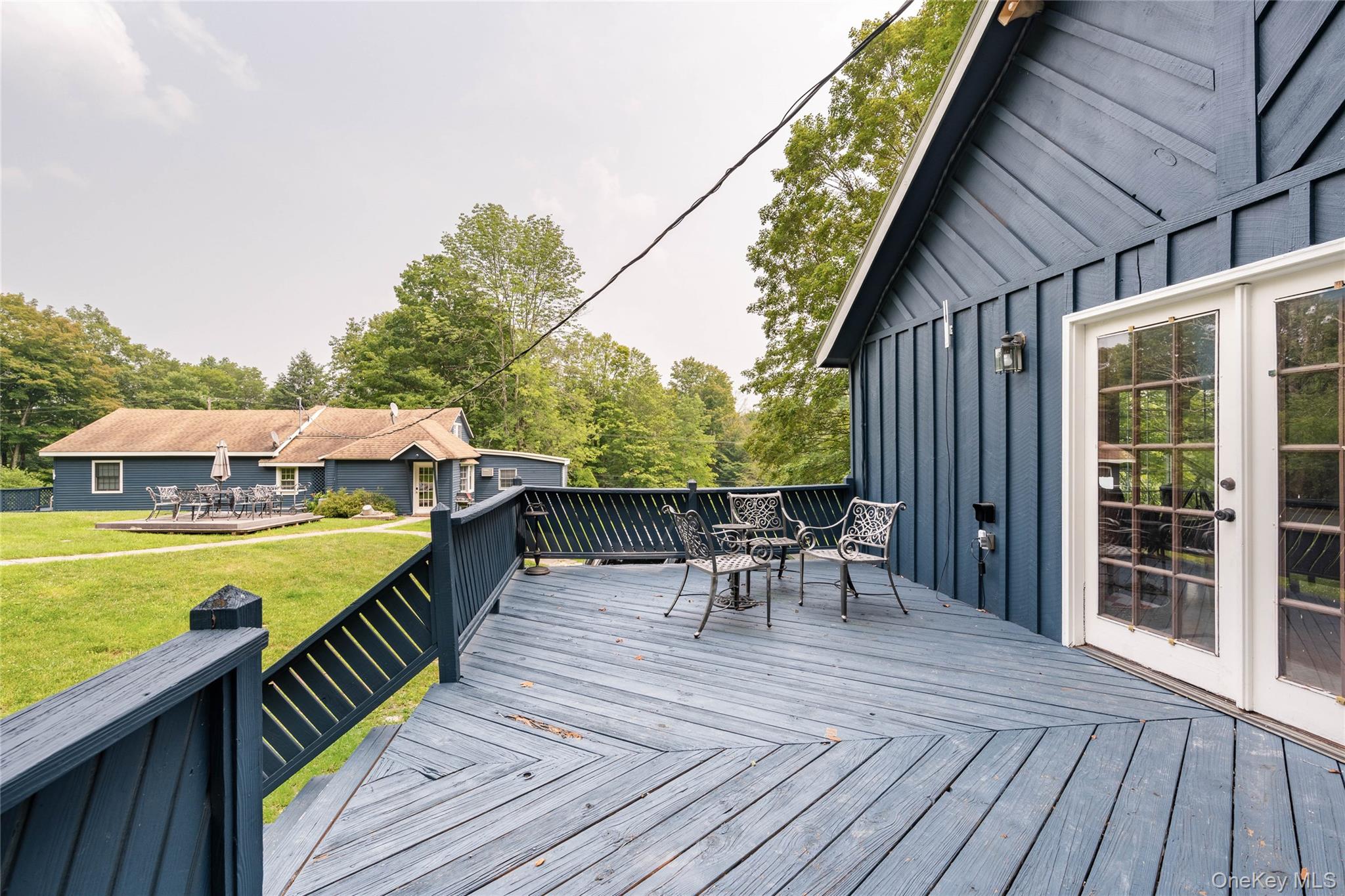 670 Creamery Road Mongaup Valley, NY 12762 - Photo 4 of 47 a view of a roof deck with table and chairs wooden floor and fence
