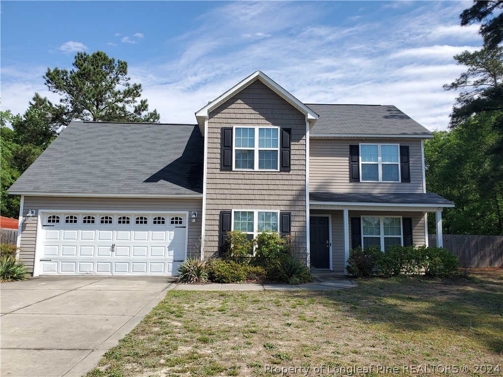 2713 Rockfish Road Raeford, NC 28376 - Photo 1 of 29 a front view of a house with a yard and garage