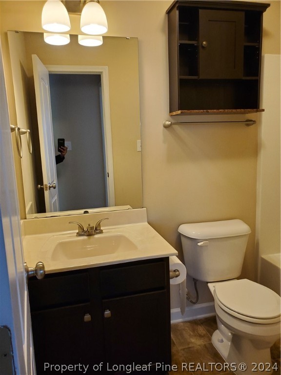 2713 Rockfish Road Raeford, NC 28376 - Photo 20 of 29 a bathroom with a sink a toilet and mirror