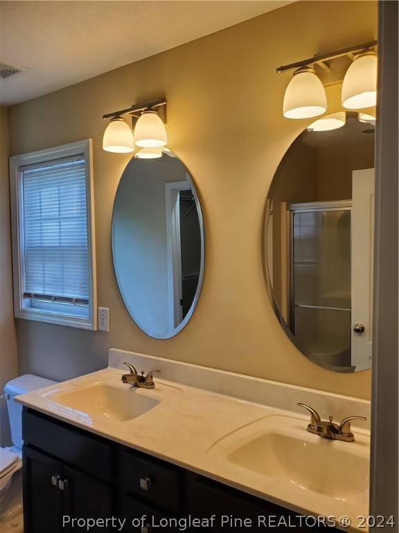 2713 Rockfish Road Raeford, NC 28376 - Photo 25 of 29 a bathroom with a sink and a mirror