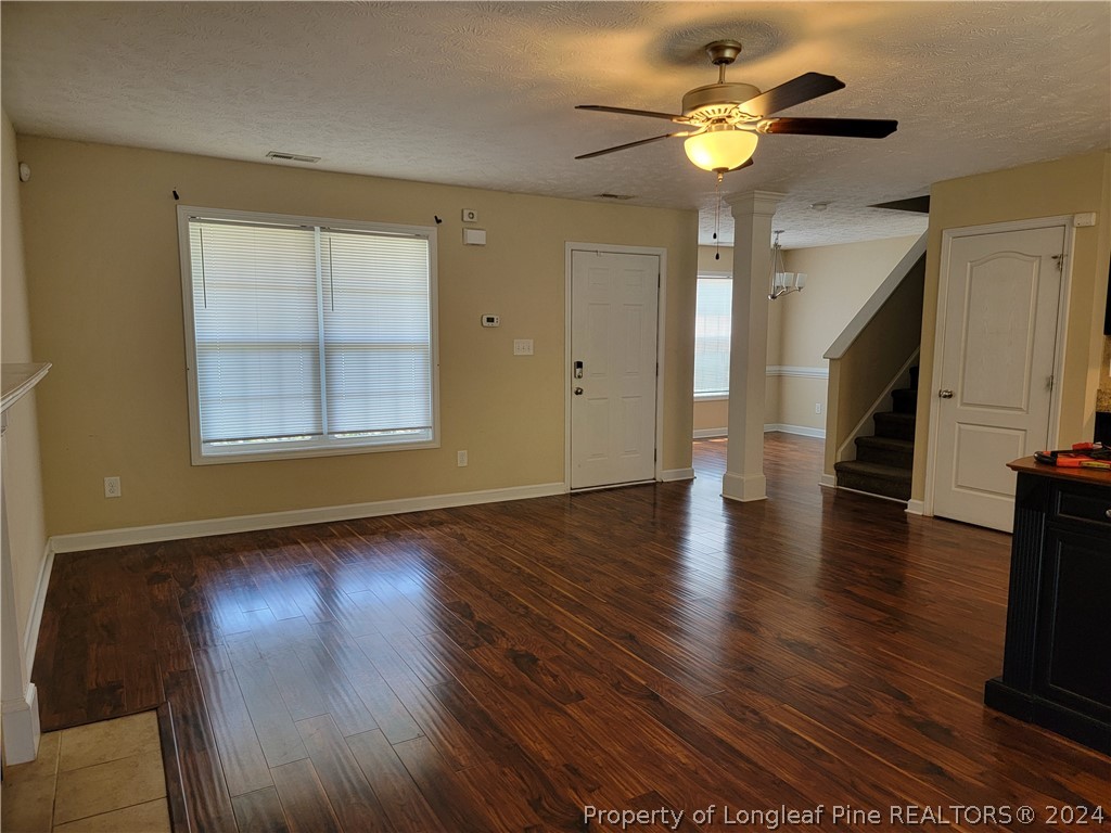 2713 Rockfish Road Raeford, NC 28376 - Photo 5 of 29 a view of an empty room with wooden floor and a window