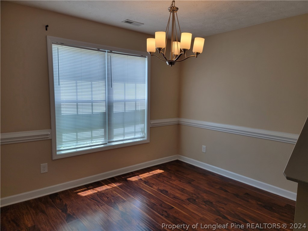 2713 Rockfish Road Raeford, NC 28376 - Photo 8 of 29 a view of empty room with wooden floor and fan