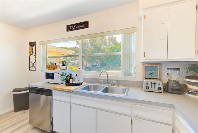 a kitchen with stainless steel appliances a sink a stove and a window