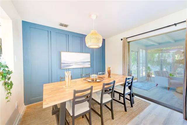 a dining room with furniture and wooden floor