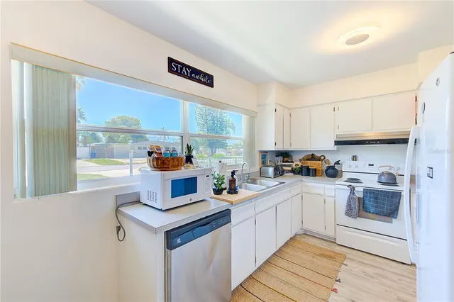 a kitchen with a stove a sink and a refrigerator