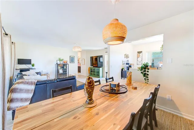 a dining room with furniture and wooden floor
