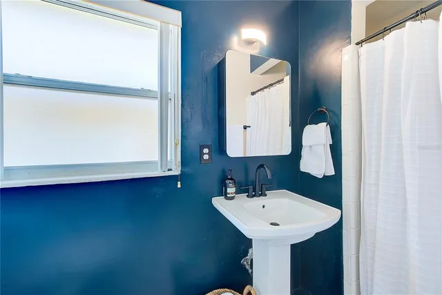 a bathroom with a sink and mirror
