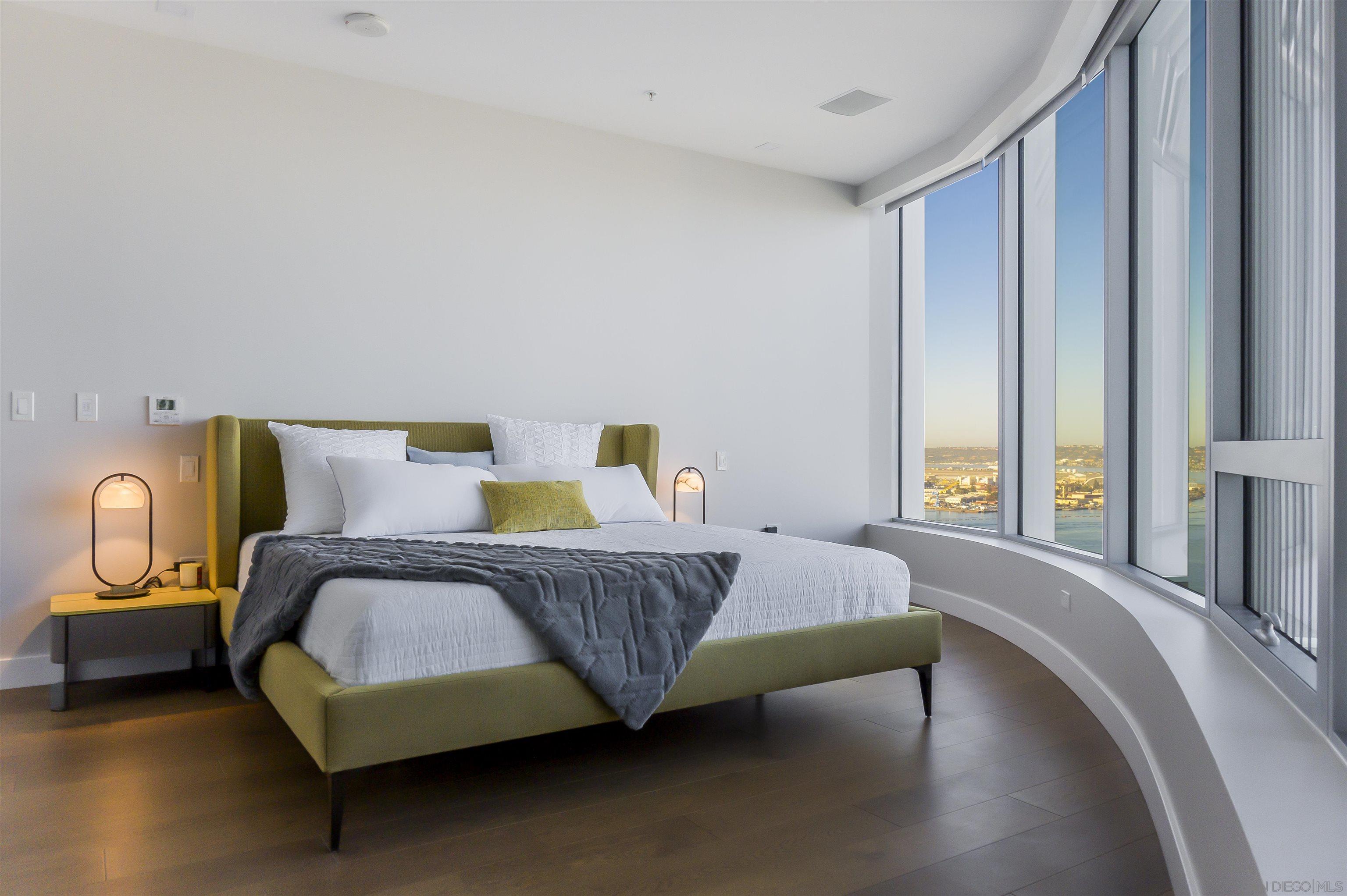 888 E Street, Unit 3602 San Diego, CA 92101 - Photo 18 of 51 a bedroom with a bed and wooden floor