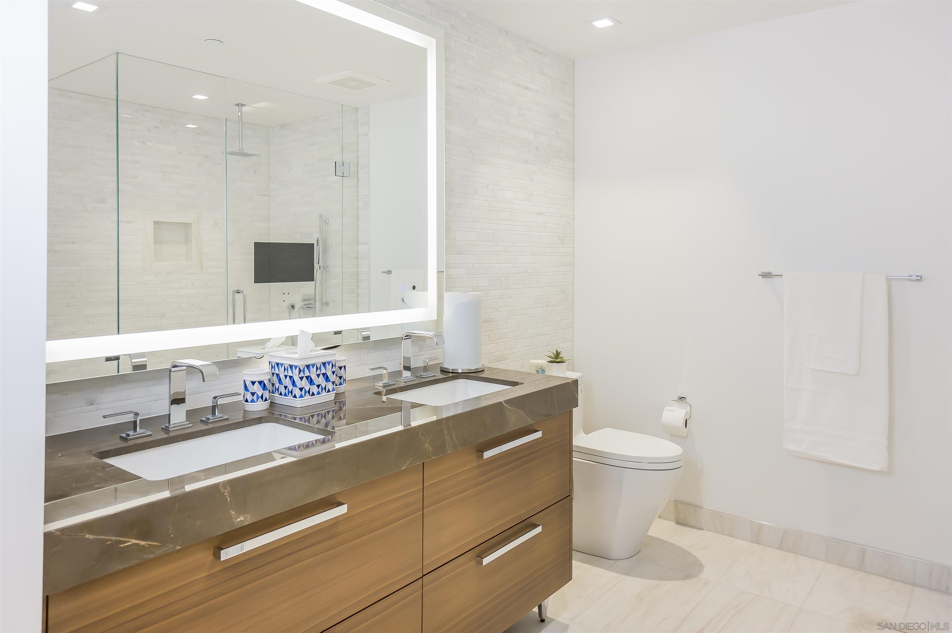 888 E Street, Unit 3602 San Diego, CA 92101 - Photo 20 of 51 a bathroom with a sink toilet double vanity and shower
