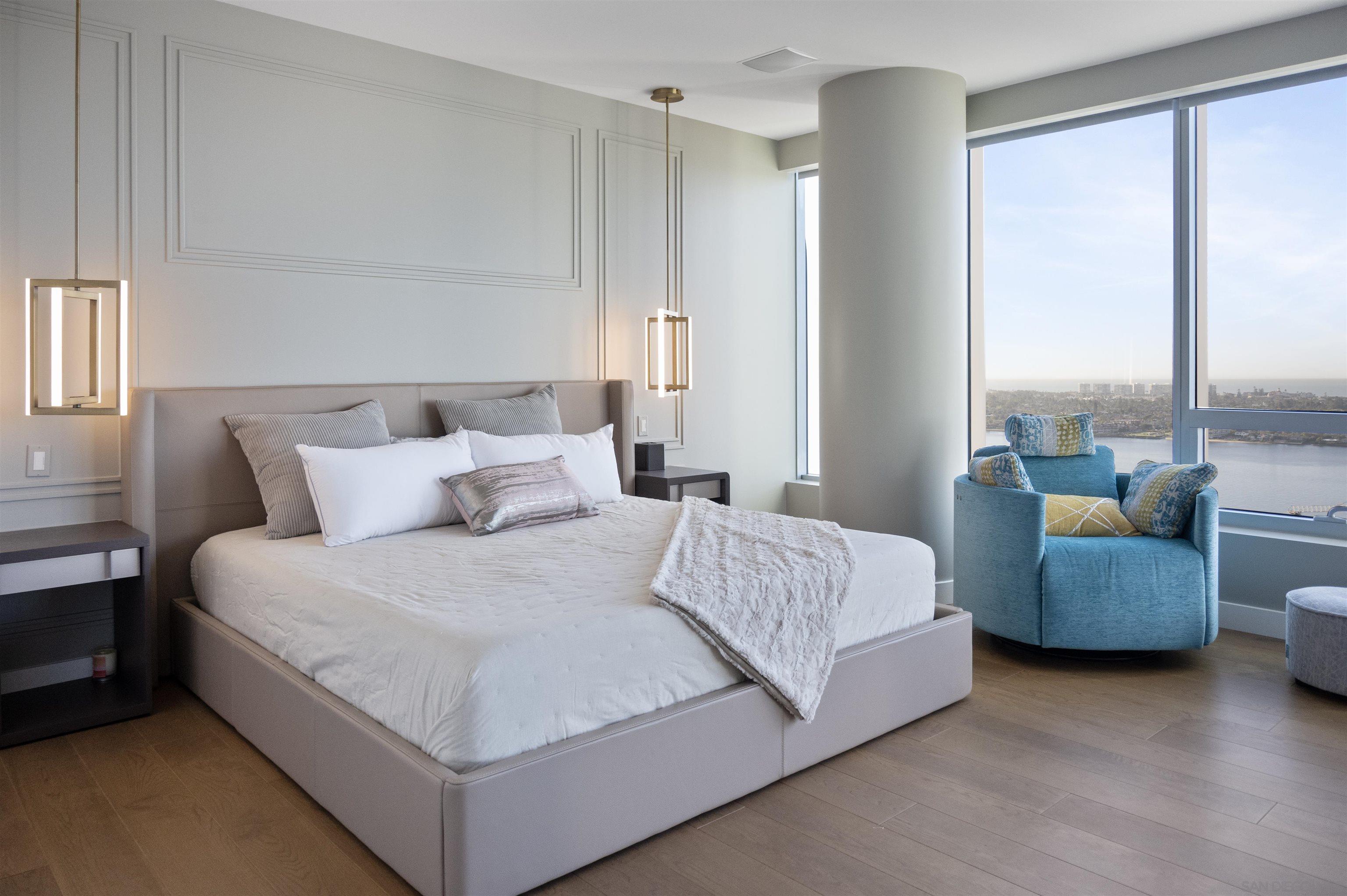 888 E Street, Unit 3602 San Diego, CA 92101 - Photo 21 of 51 a large bed sitting in a bedroom next to a window