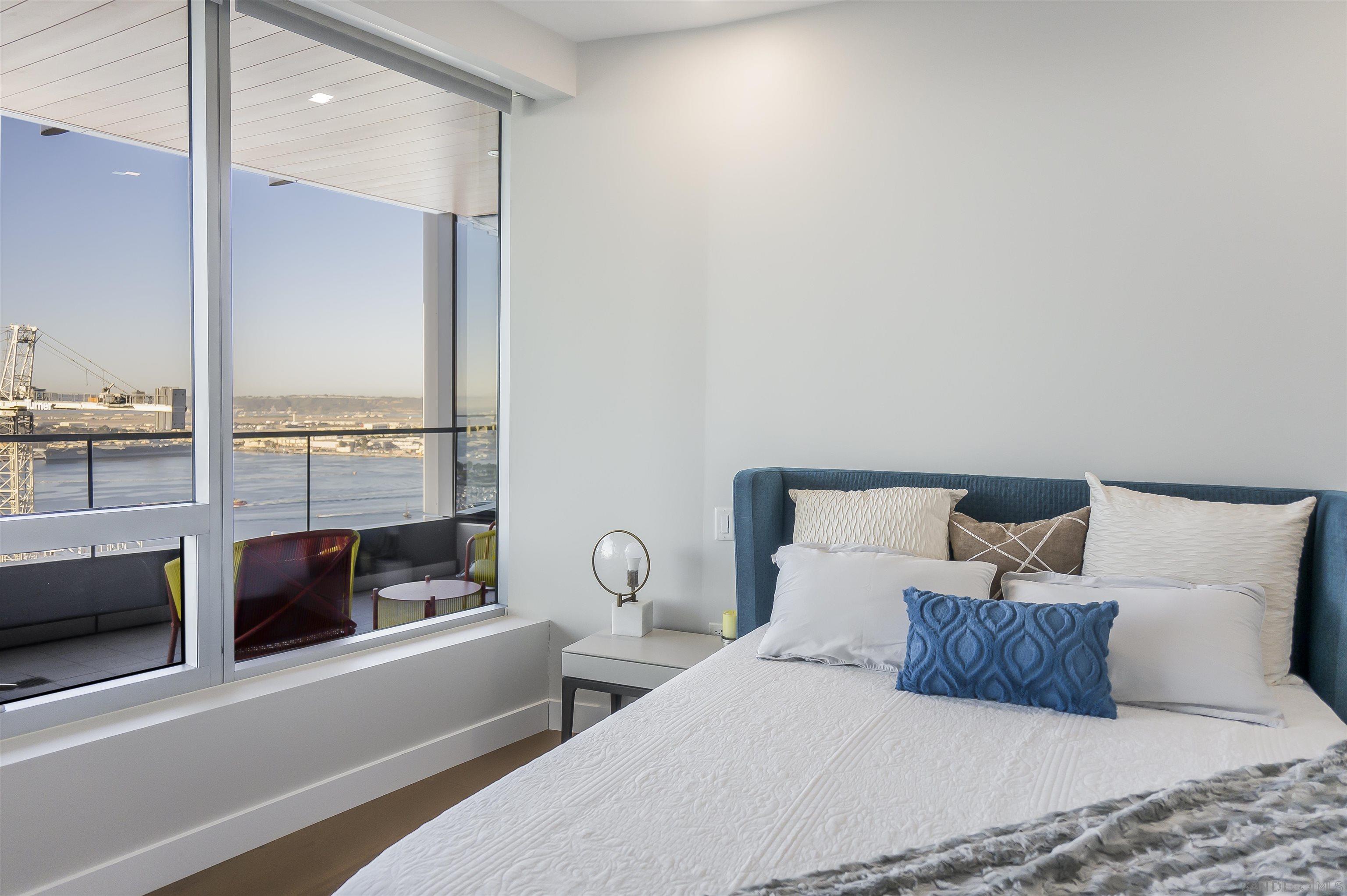 888 E Street, Unit 3602 San Diego, CA 92101 - Photo 24 of 51 a bedroom with a large bed and a large window