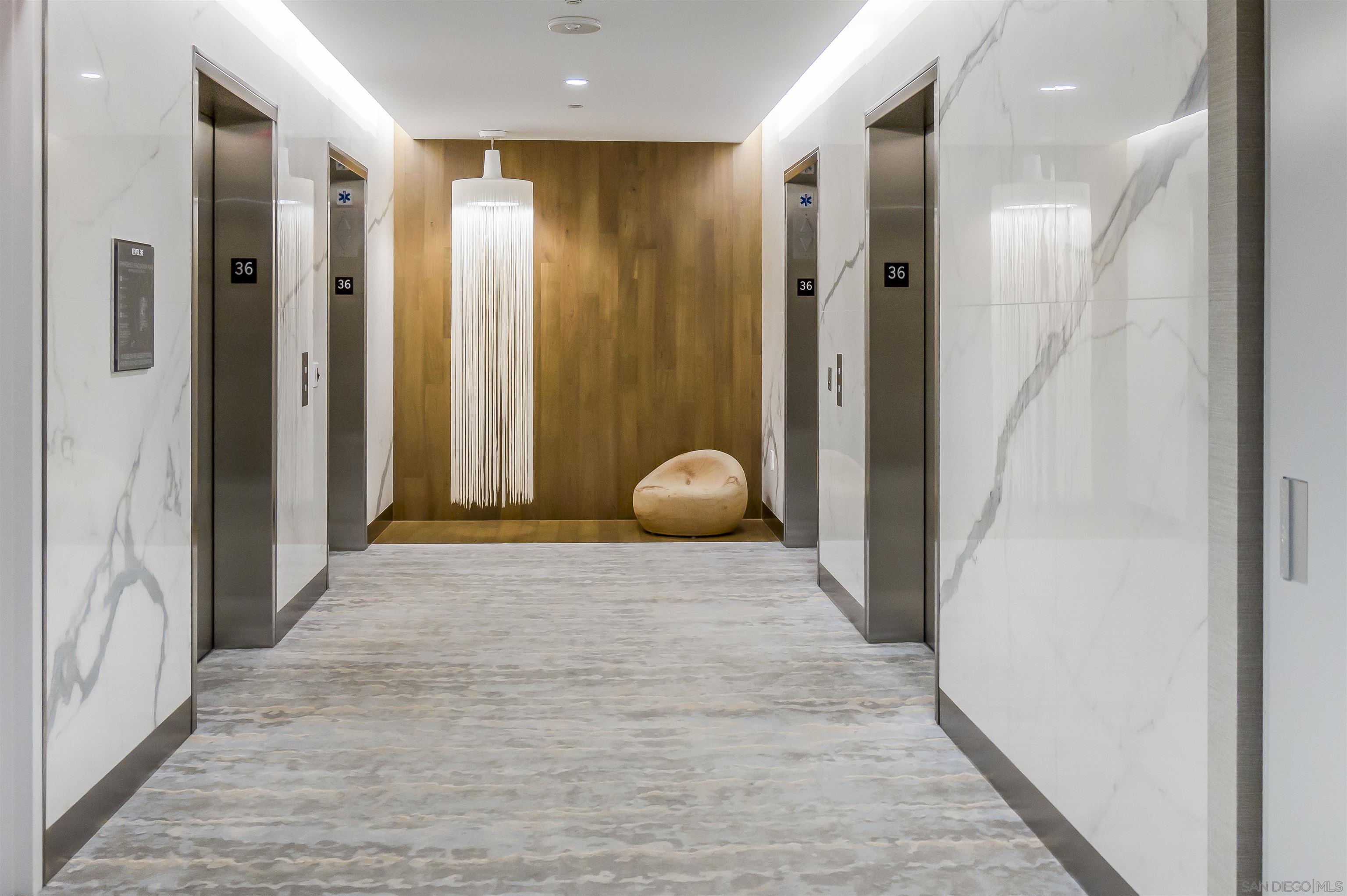 888 E Street, Unit 3602 San Diego, CA 92101 - Photo 31 of 51 a view of a hallway with wooden cabinets