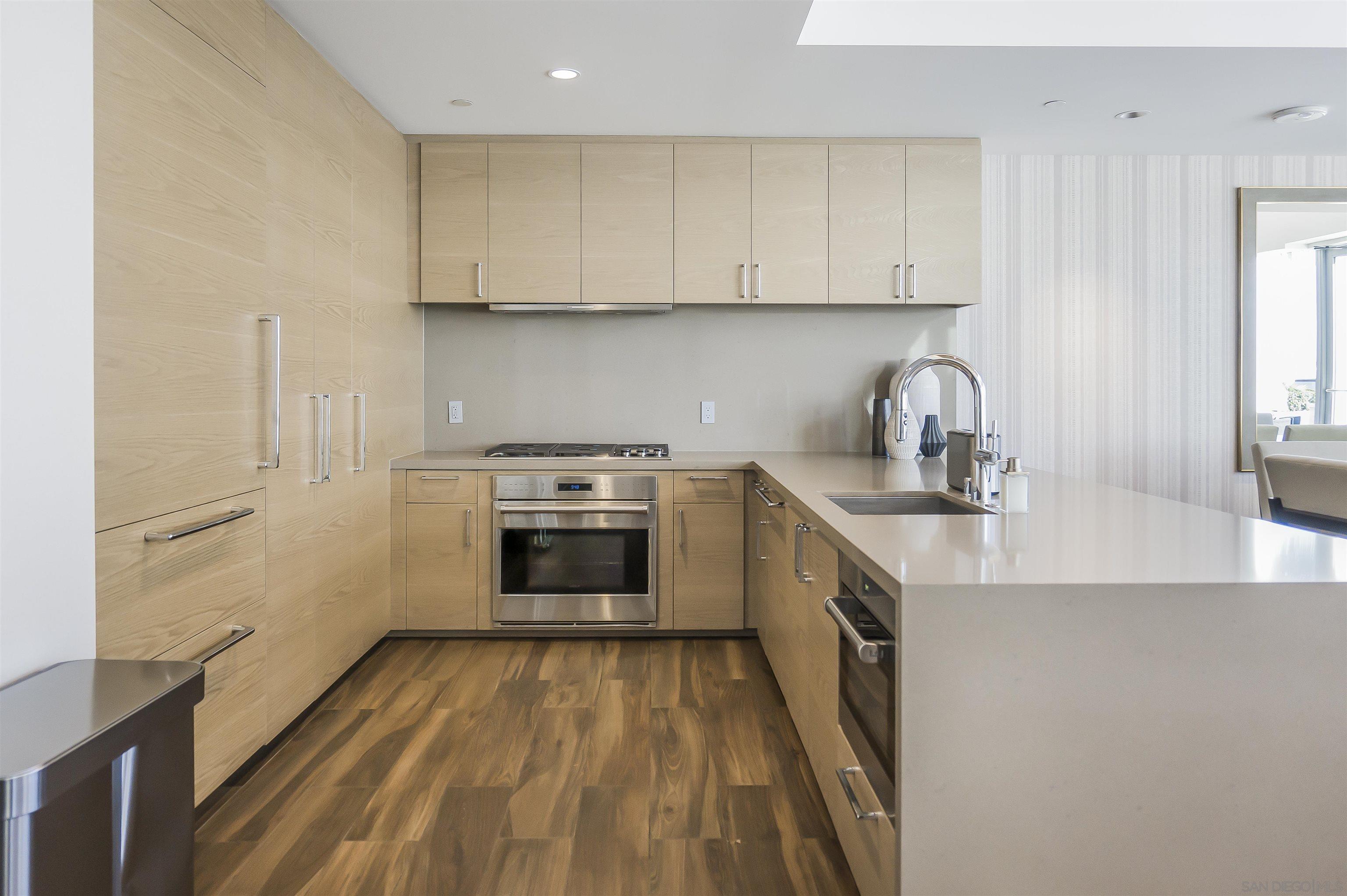 888 E Street, Unit 3602 San Diego, CA 92101 - Photo 43 of 51 a kitchen with a sink a stove and cabinets