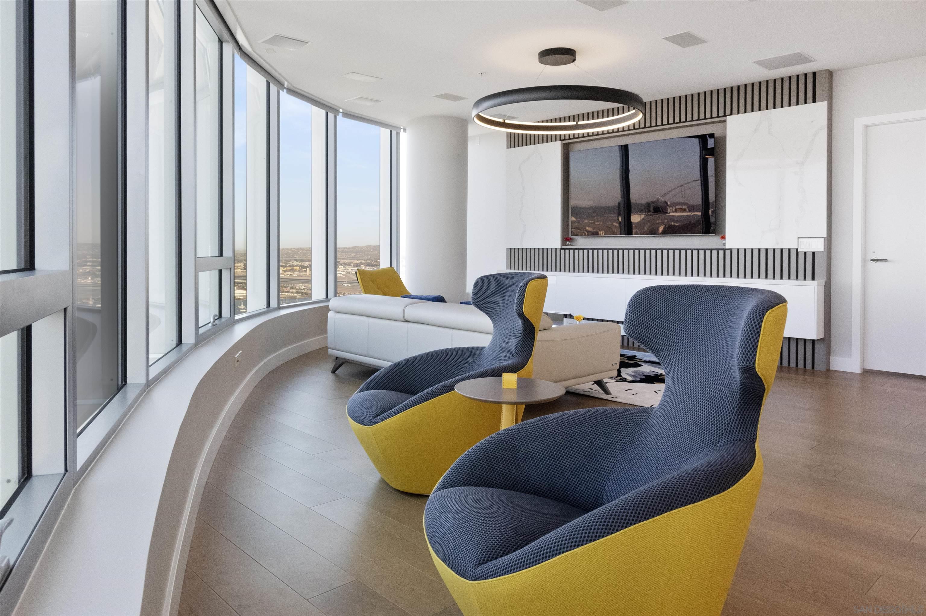 888 E Street, Unit 3602 San Diego, CA 92101 - Photo 9 of 51 a living room with furniture and large windows