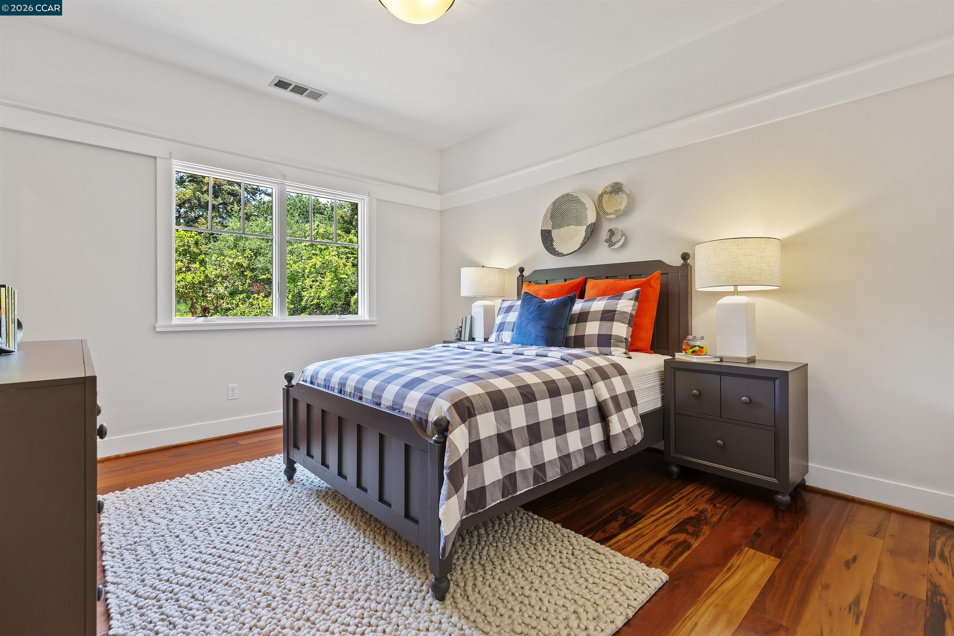 1754 Reliez Valley Road Lafayette, CA 94549 - Photo 28 of 60 a bedroom with a bed and wooden floor