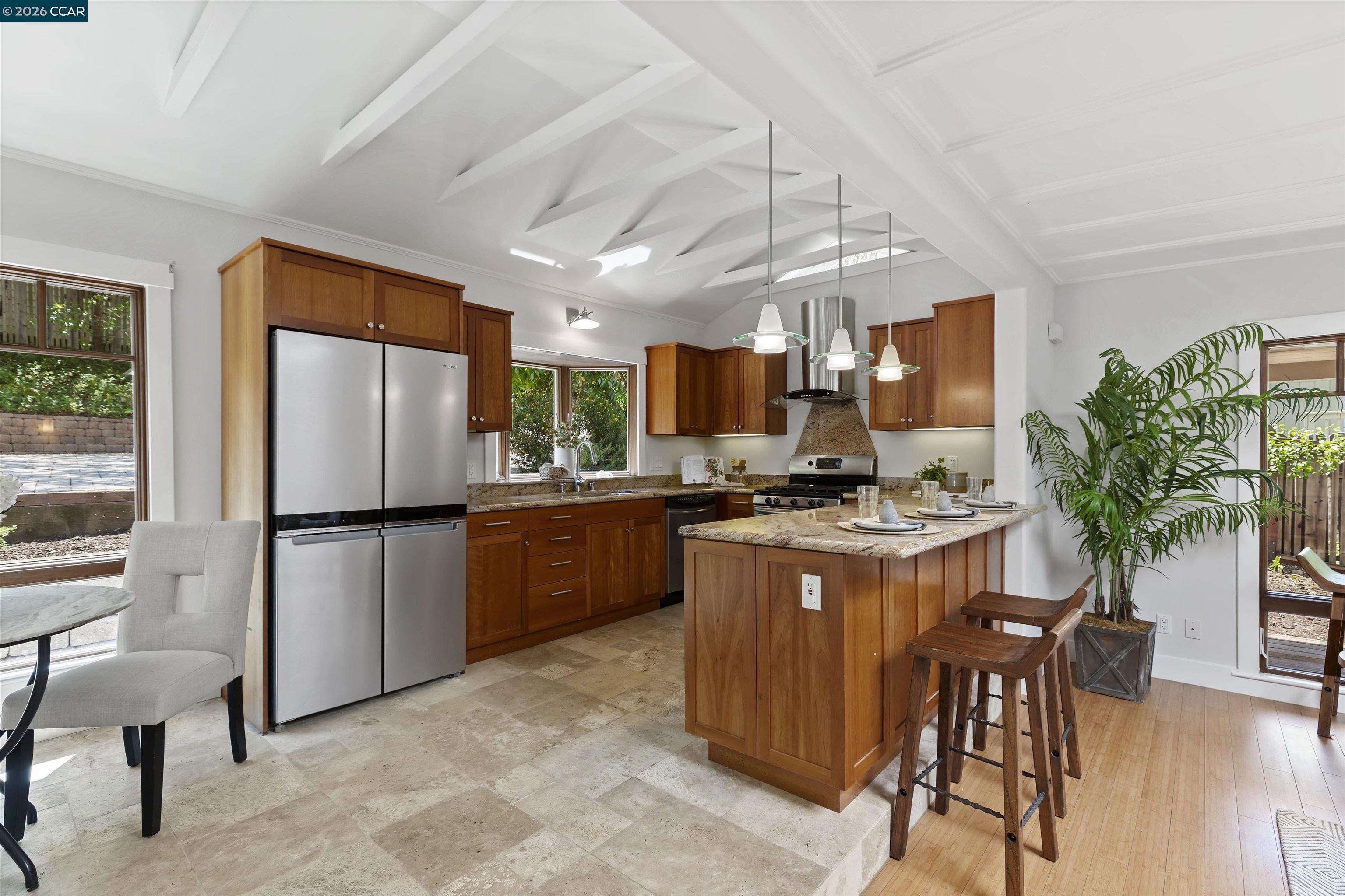 1754 Reliez Valley Road Lafayette, CA 94549 - Photo 55 of 60 a kitchen with granite countertop a refrigerator a stove a sink a dining table and chairs