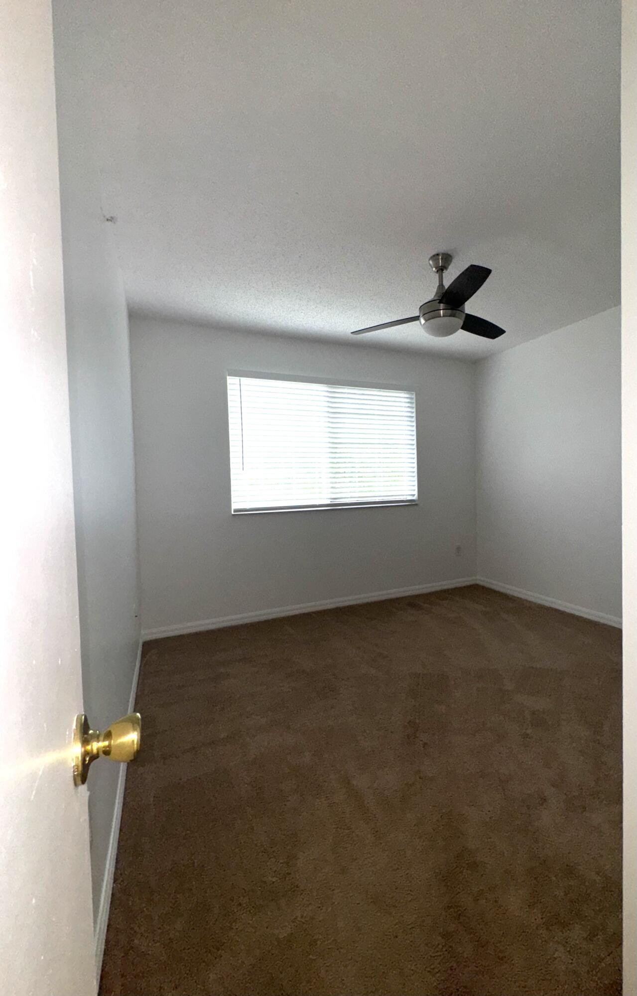 1300 Crestwood Court South, Unit 1319 Royal Palm Beach, FL 33411 - Photo 11 of 14 a view of an empty room with a window