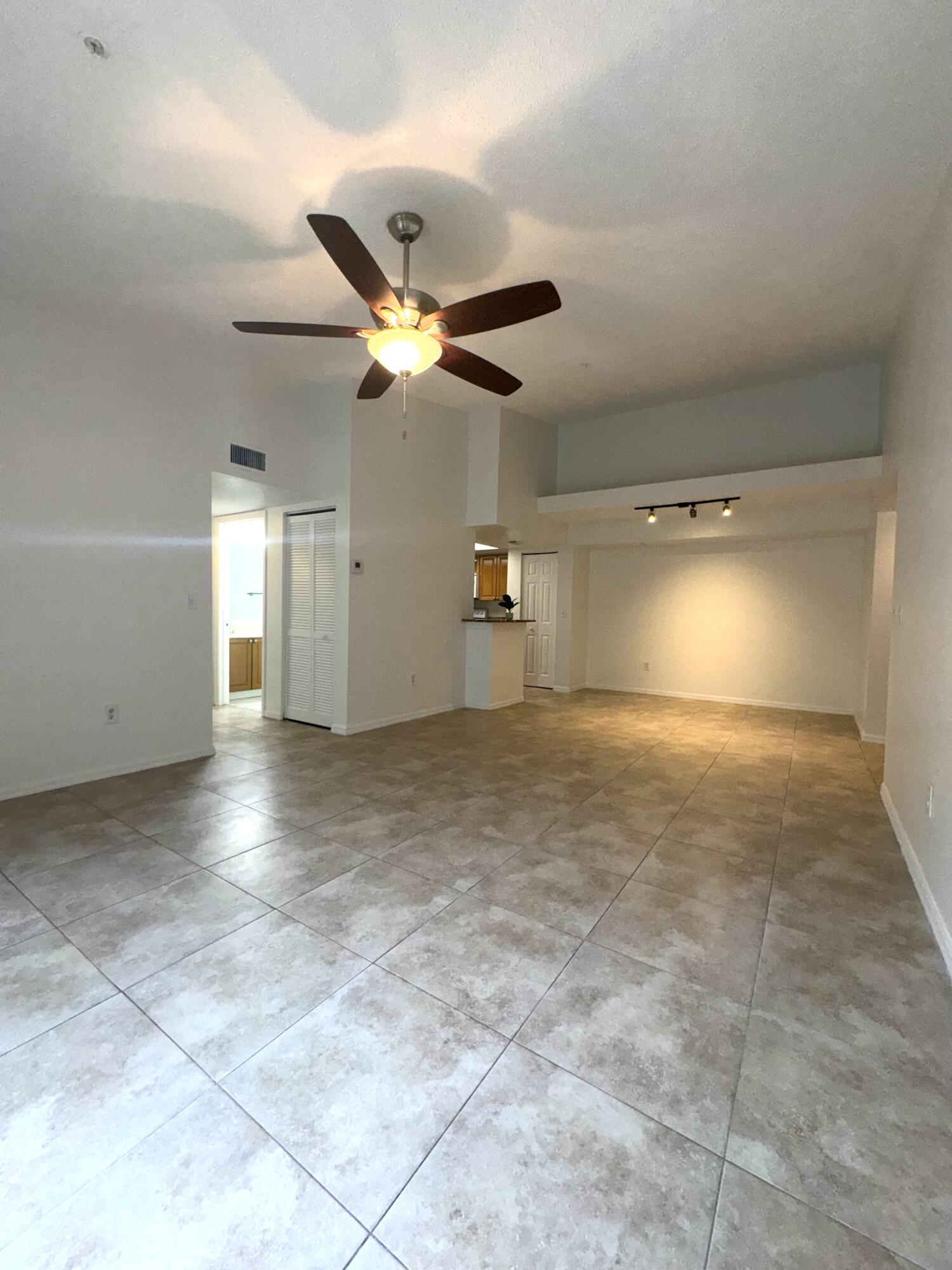 1300 Crestwood Court South, Unit 1319 Royal Palm Beach, FL 33411 - Photo 4 of 14 a view of a livingroom with a ceiling fan and window