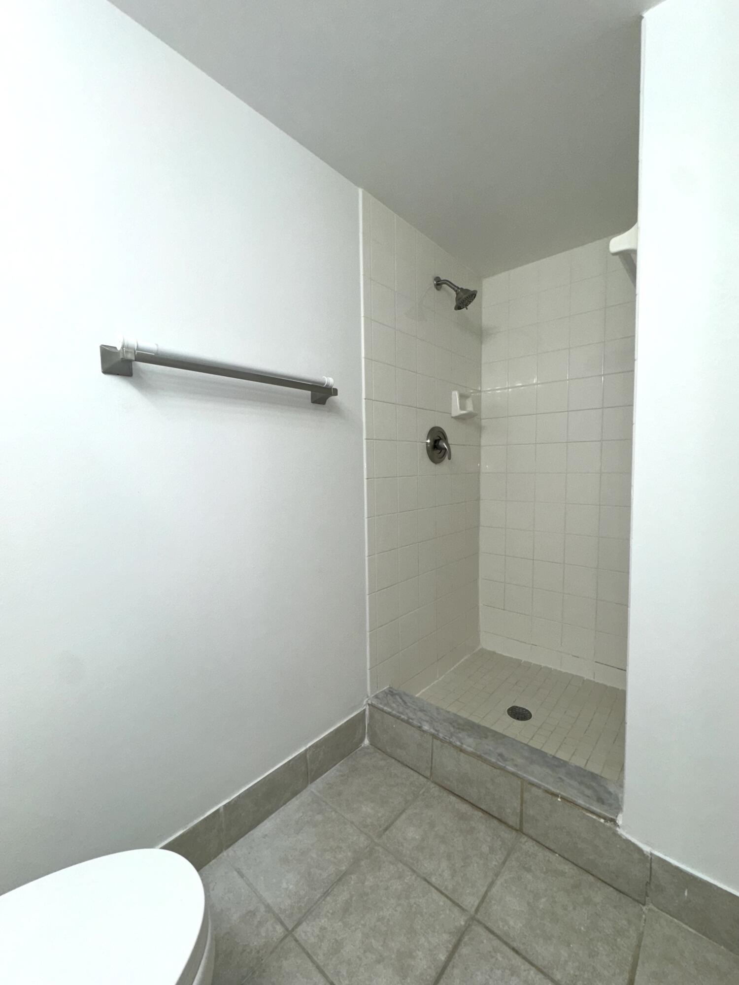 1300 Crestwood Court South, Unit 1319 Royal Palm Beach, FL 33411 - Photo 10 of 14 a bathroom with a shower and toilet