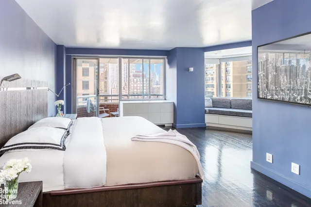 a bathroom with a tub a sink and a large mirror