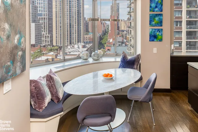 a outdoor dining space with furniture and wooden floor