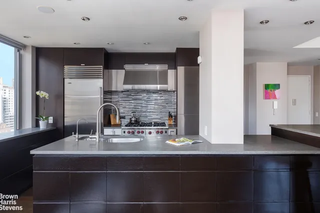 a kitchen with a sink and a refrigerator
