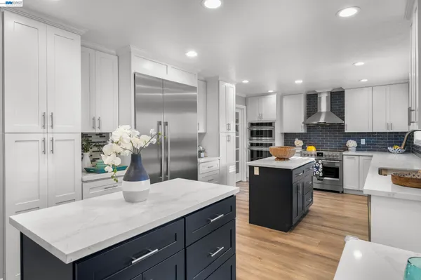 a kitchen with a refrigerator and a sink