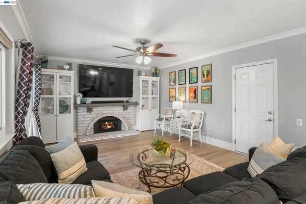 a living room with furniture a fireplace and a flat screen tv