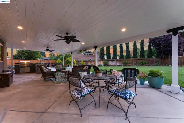 a view of a patio with a dining table and chairs