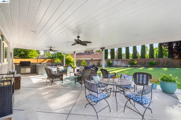 a view of a house with a yard and sitting area