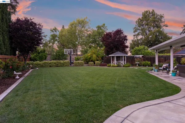 a house view with a sitting space and garden