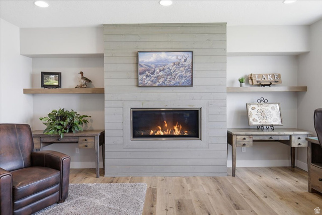 21 Pier Place Tooele, UT 84074 - Photo 67 of 112 Modern linear fireplace with a light-toned shiplap surround, flanked by built-in alcoves featuring floating wood shelves