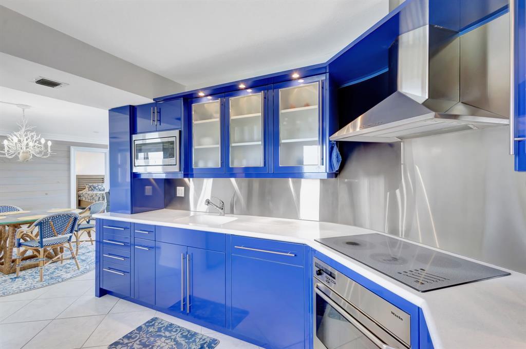 300 Ocean Trail Way, Unit 907 Jupiter, FL 33477 - Photo 11 of 42 a kitchen with a stove and a cabinet